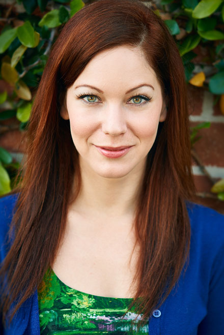 Female actor with red hair and green eyes poses in Hollywood