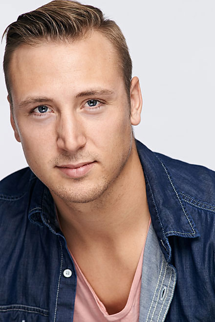 Handsome male actor headshot with studio lighting and solid white background