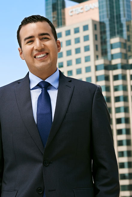 Real estate agent photographed on rooftop in Downtown Los Angeles with office buildings in background